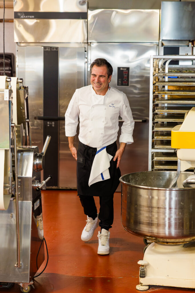 Chef walking and smiling naturally in professional kitchen environment