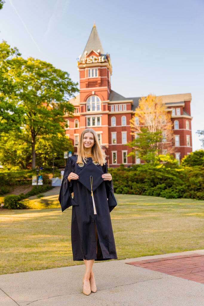 Gabriela standing in cap and gown in front of the Georgia Tech Tower for graduation photos in Atlanta