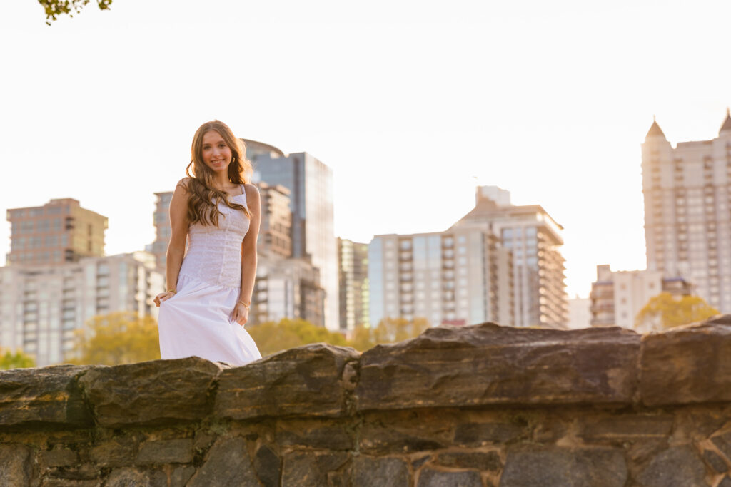 Senior holding dress with Midtown skyline behind her