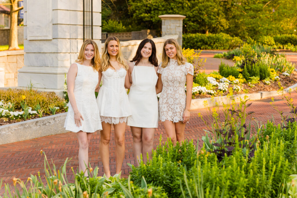 Close crop of four girls hugging under Emory arch graduation photos Atlanta