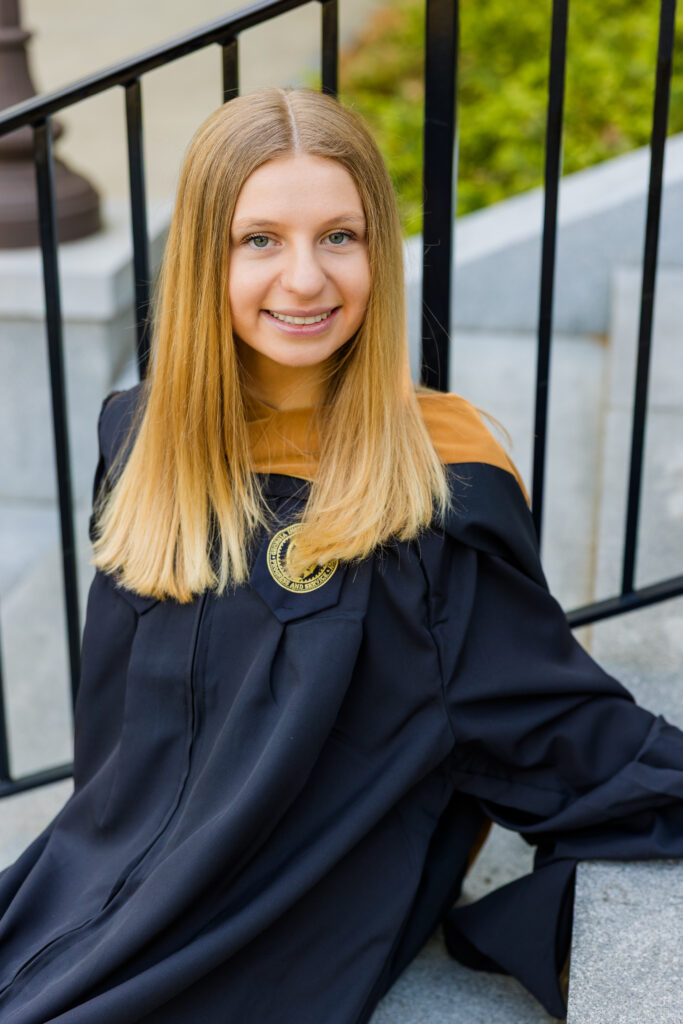Close-up of Gabriela sitting on the Georgia Tech stairs for graduation portraits