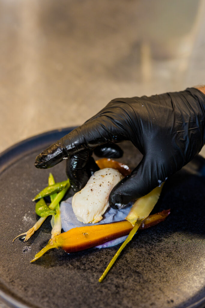 Chef adding final touch to vegetarian dish