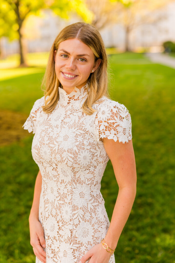Close up of McKenzie with Emory quadrangle in background graduation