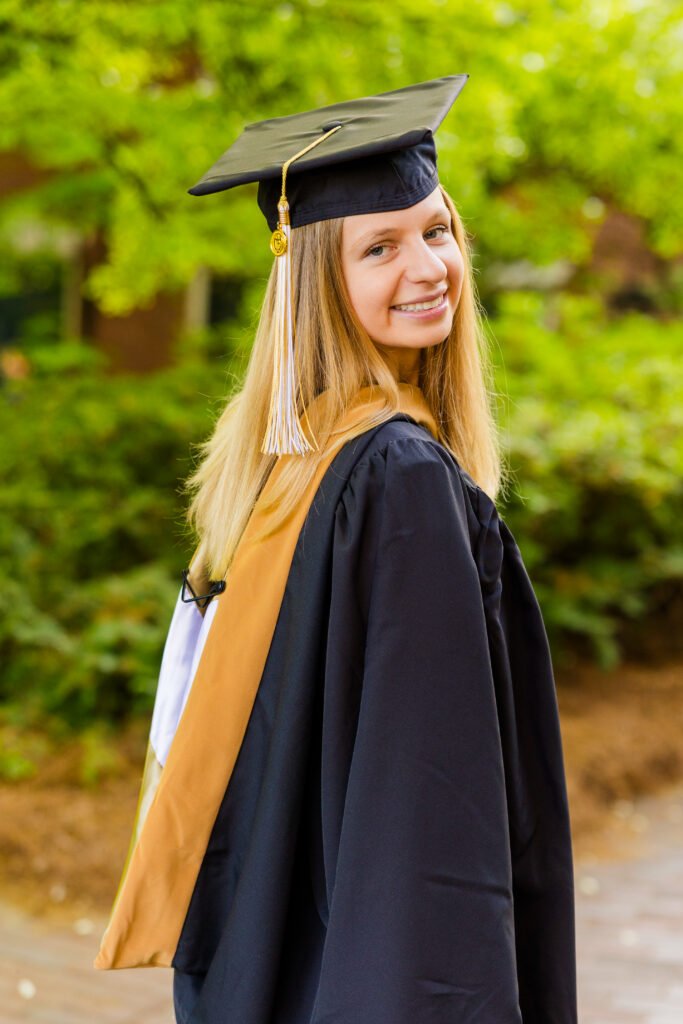 Gabriela looking over her shoulder during graduation photos at Georgia Tech