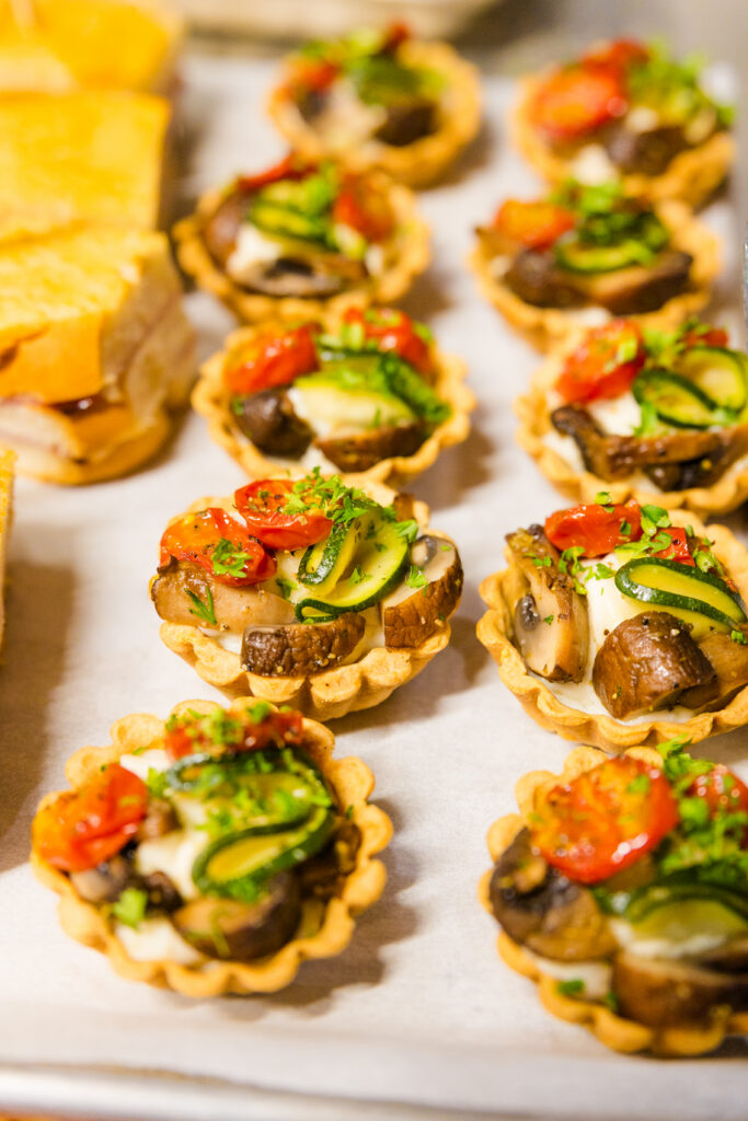 Individual vegetarian tarts ready for catering delivery
