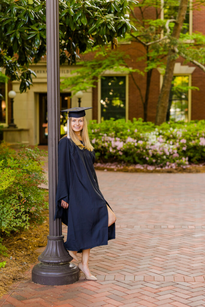 Wide portrait of Gabriela leaning against a lamp post on Georgia Tech campus