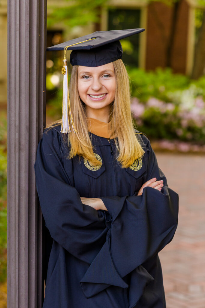 Close-up portrait of Gabriela leaning against a lamp post at Georgia Tech