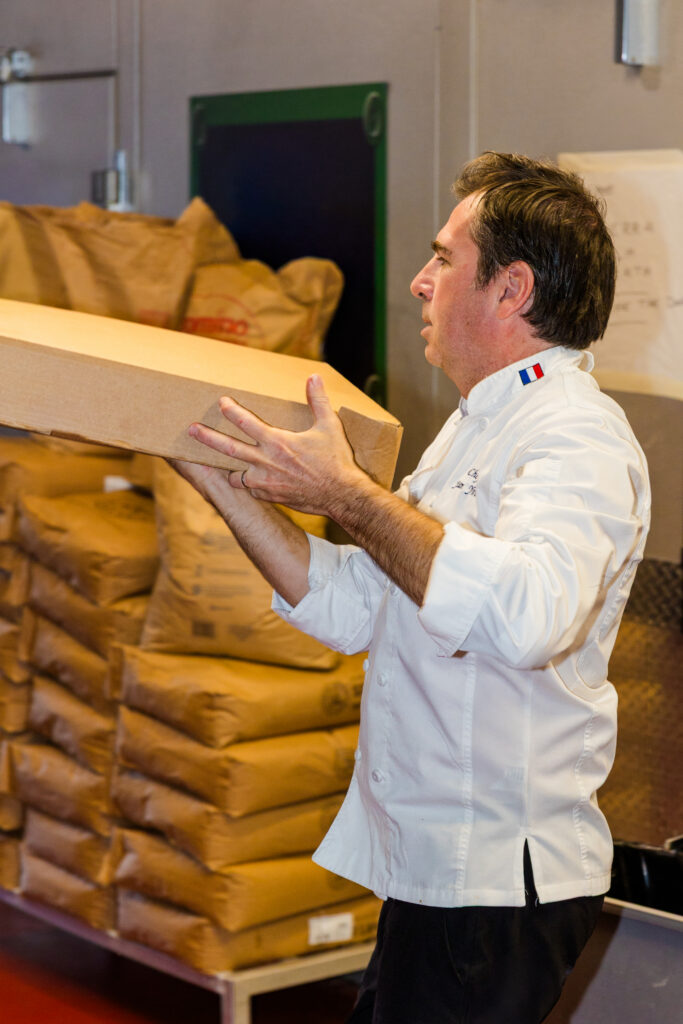 Chef stacking catering delivery boxes ready for transport