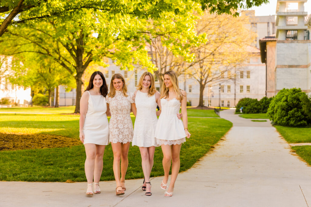Four girls walking toward camera on Emory campus graduation session