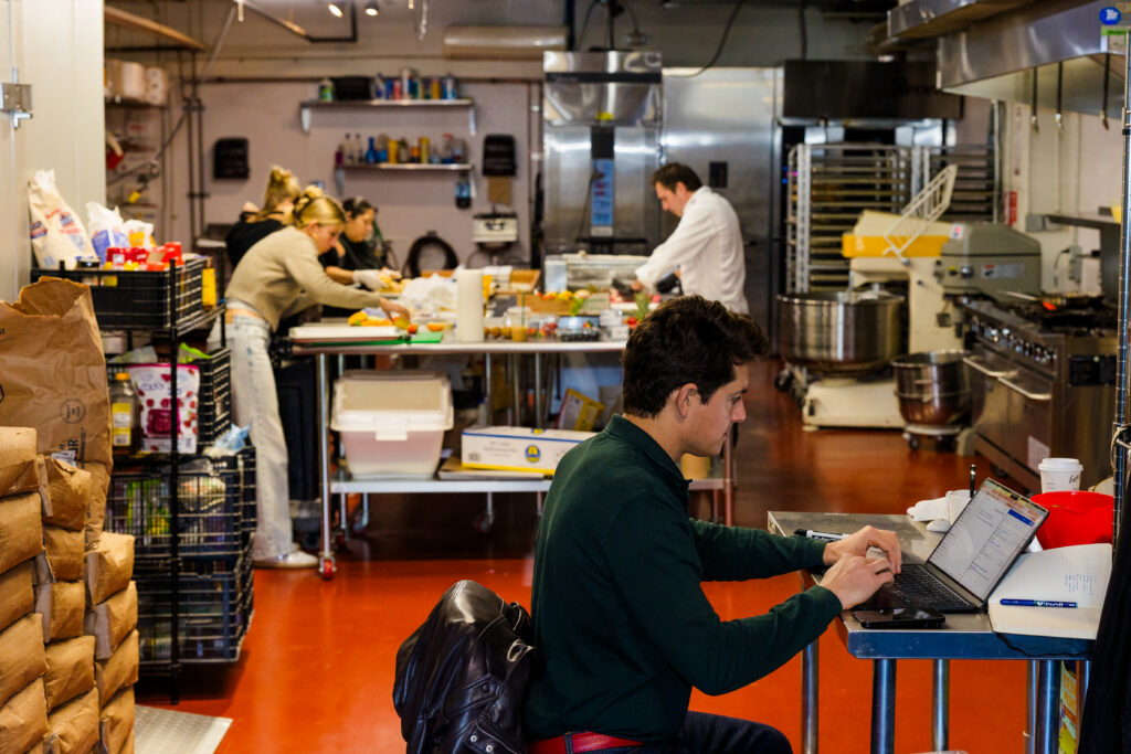Wide view of multiple employees working in professional kitchen