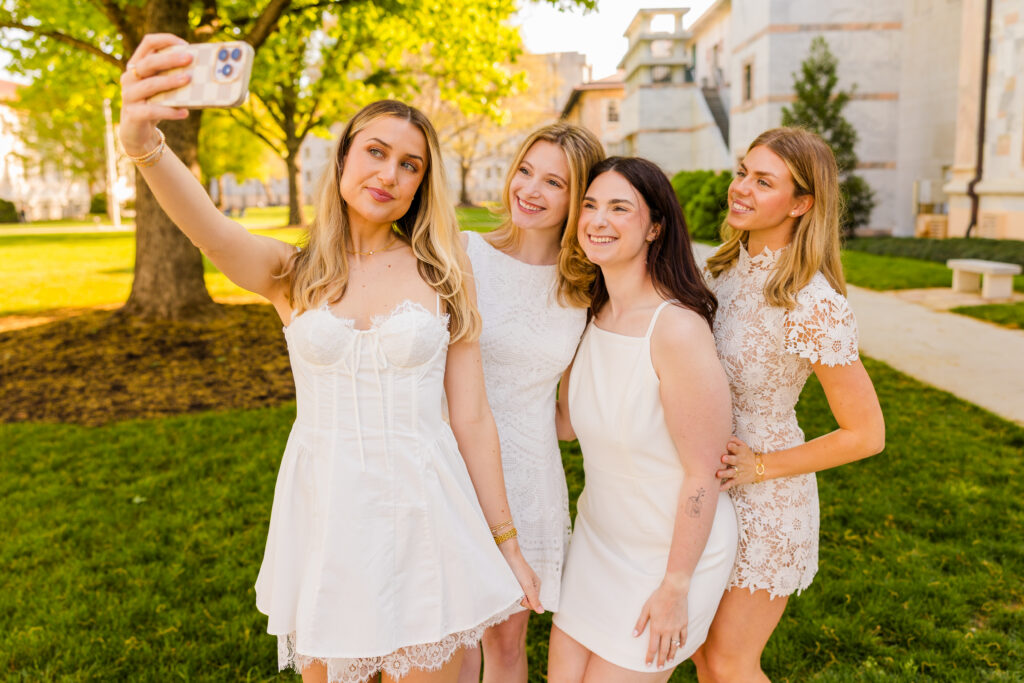Four girls taking a selfie together during Emory graduation session