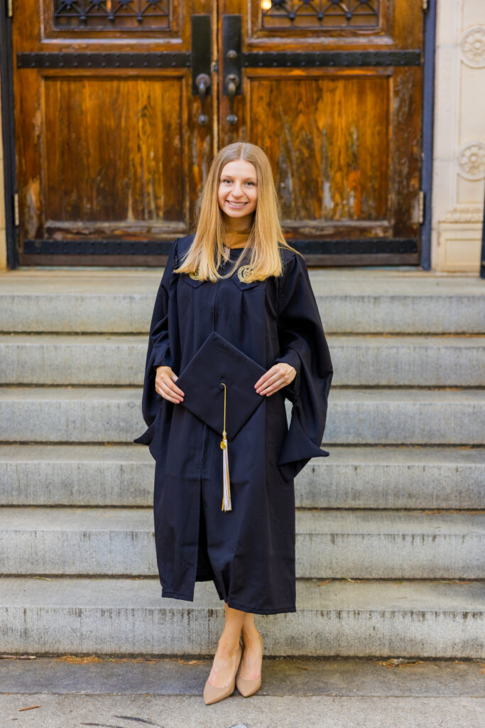 Gabriela standing in front of an old wooden door on Georgia Tech campus