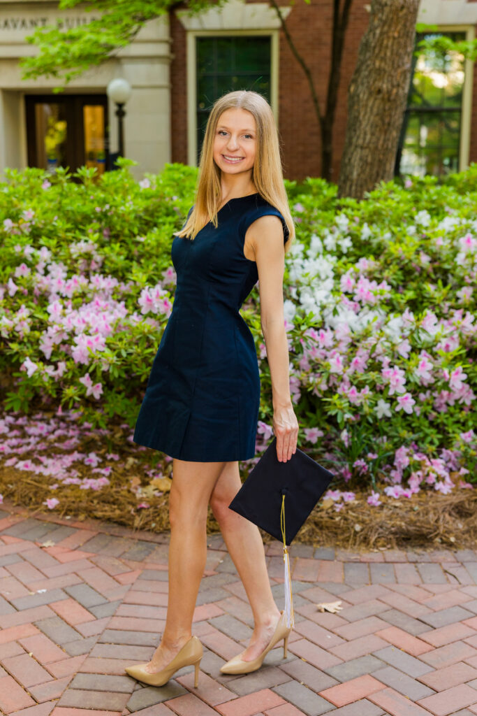 Gabriela walking across campus in a blue dress during Georgia Tech graduation session