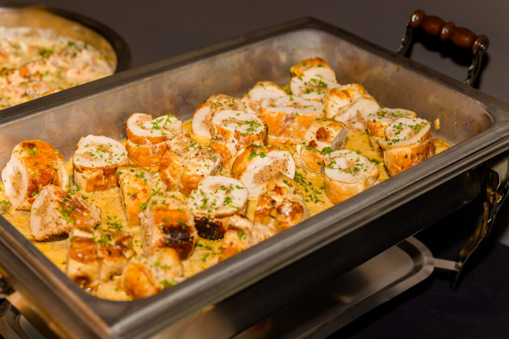 Catering pan filled with meat in sauce