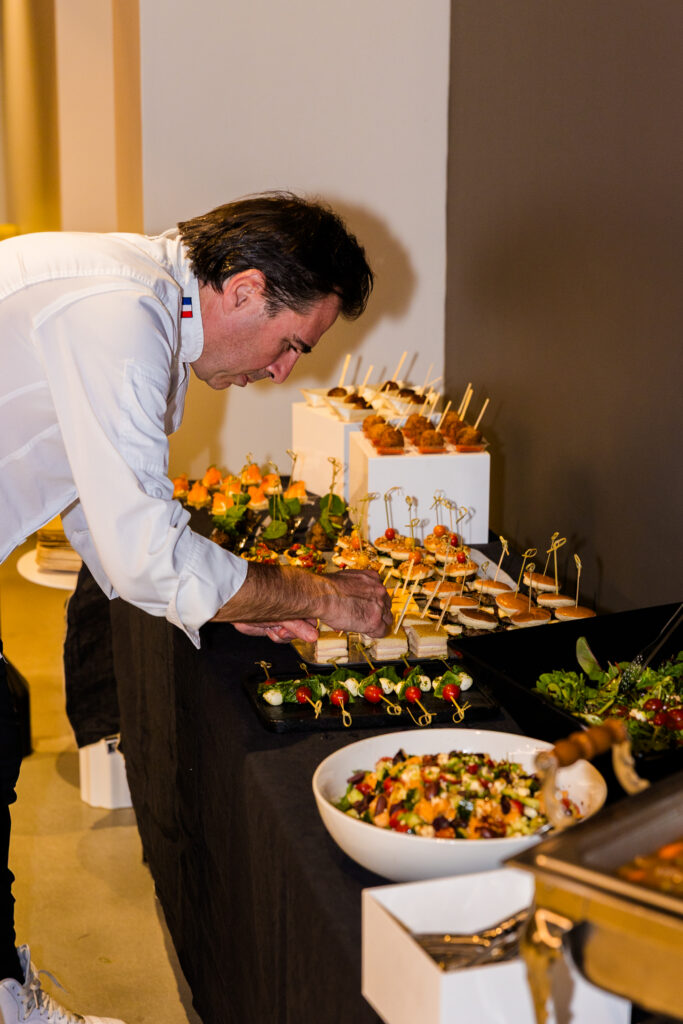 Chef adding final touches to corporate buffet setup