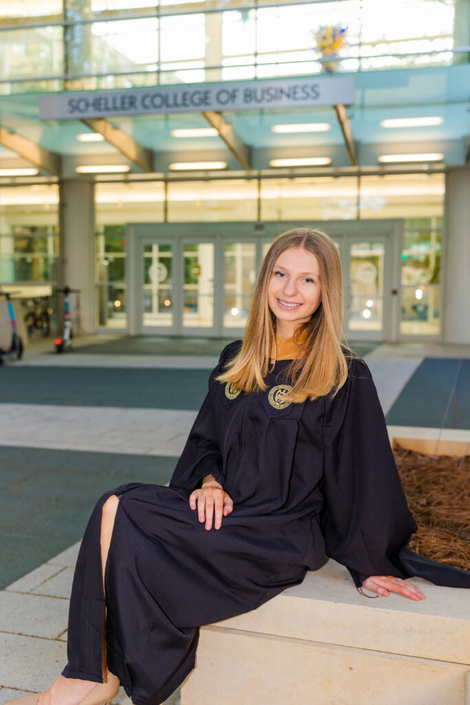 Gabriela sitting with Scheller College of Business in the background