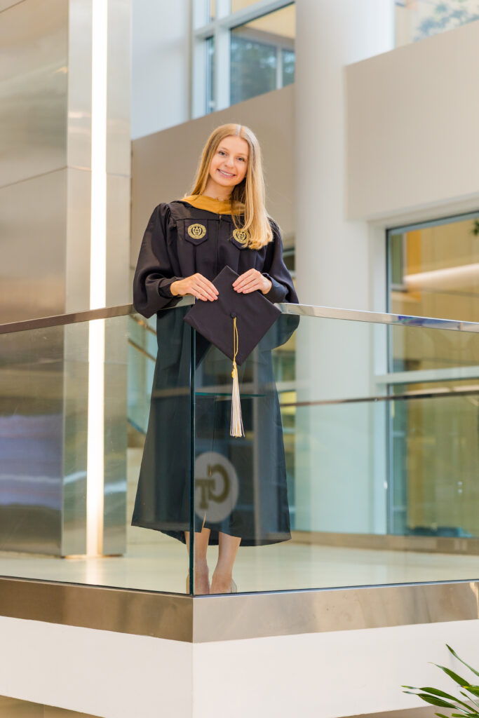 Gabriela posing on the modern staircase inside Scheller College of Business