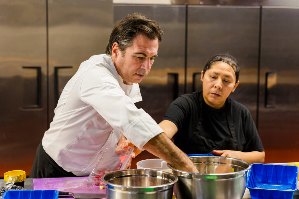 Chef and employee focused on their work in professional kitchen