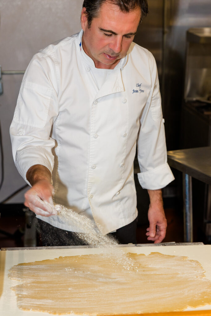 Chef throwing flour over dough creating dynamic motion effect