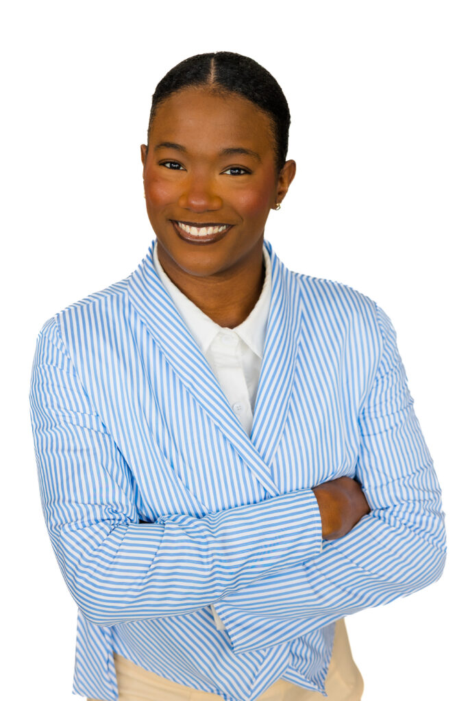 Professional corporate headshot of woman in striped blazer, arms crossed, white backdrop, Atlanta corporate photography by Laure Photography.